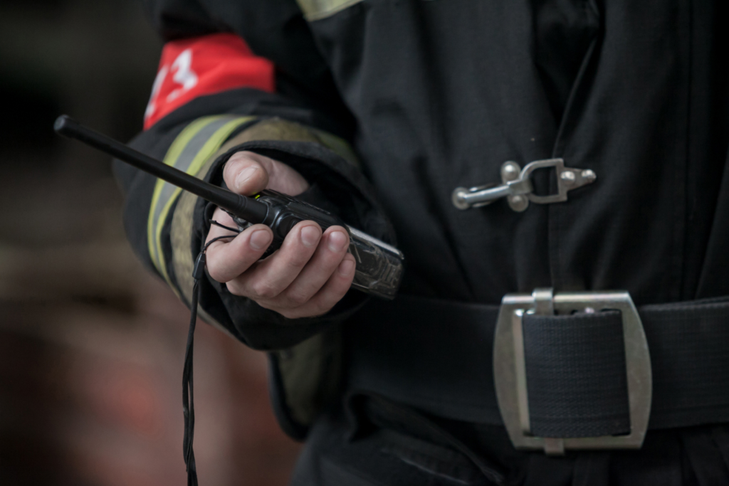 Firefighter holding radio in hand